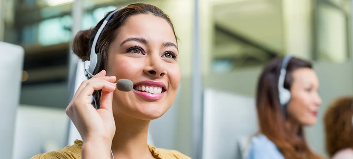 member service representative with phone headset smiling